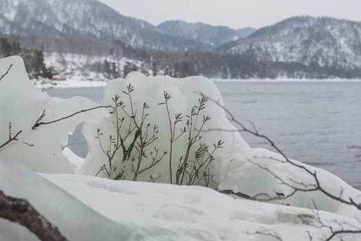unfrozen Lake Teletskoye in winter. Russia Altai Krai.