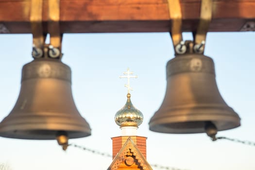 view of the bells and the dome of a small rural church in the village of Uval, Russia-Siberia.