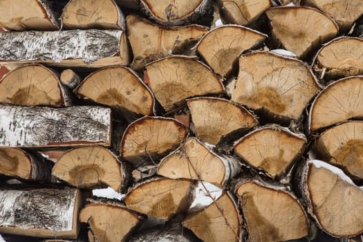 A pile of birch wood. prepared for the winter for kindling the village stove.