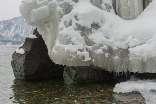 unfrozen Lake Teletskoye in winter. Russia Altai Krai.
