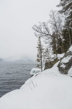 unfrozen Lake Teletskoye in winter. Russia Altai Krai.