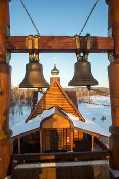 view of the bells and the dome of a small rural church in the village of Uval, Russia-Siberia.