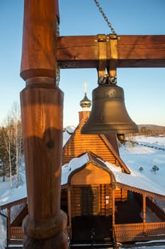 view of the bells and the dome of a small rural church in the village of Uval, Russia-Siberia.
