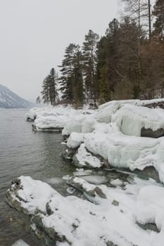 unfrozen Lake Teletskoye in winter. Russia Altai Krai.