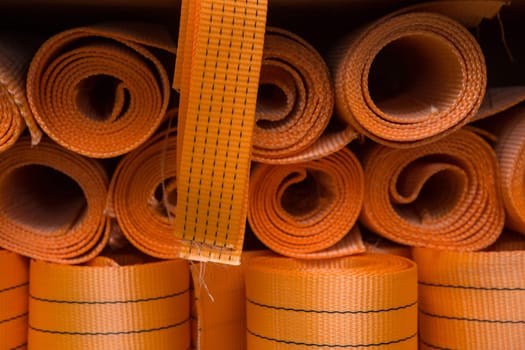 Industrial sewing machine sews a webbing sling. Manufacture of textile slings and tie straps