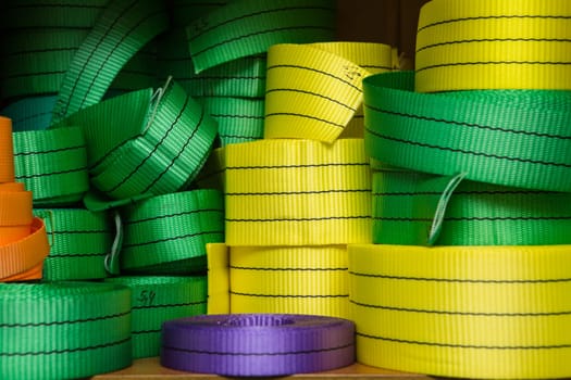 Industrial sewing machine sews a webbing sling. Manufacture of textile slings and tie straps