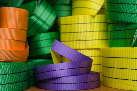 Industrial sewing machine sews a webbing sling. Manufacture of textile slings and tie straps