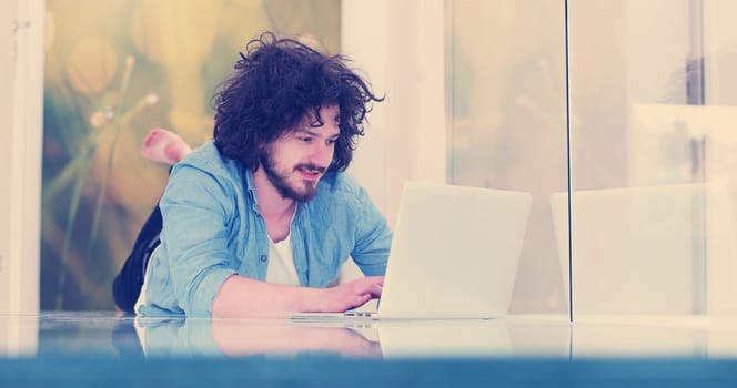 Real man Using laptop on the floor At Home  Enjoying Relaxing