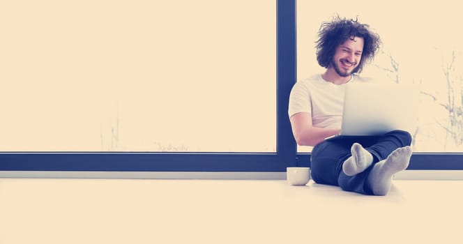 Real man Using laptop on the floor At Home  Enjoying Relaxing
