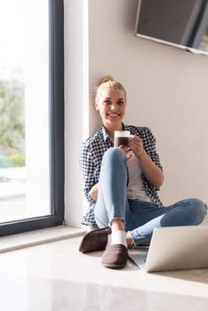 Real Woman Using laptop At Home on the floor Drinking Coffee Enjoying Relaxing