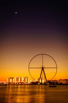 Twilight view of Bluewaters Island and Ain Dubai during construction, Dubai, UAE