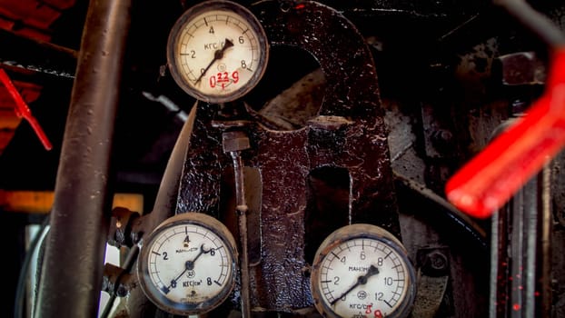 Closeup image of old vintage valves and gauges on steam engine at old train