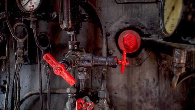Closeup image of vintage gauges and valves at train steam engine