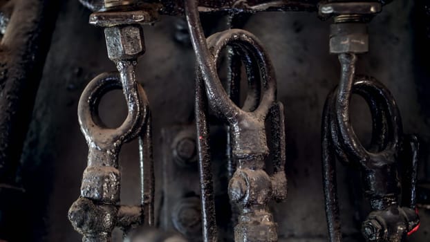 Macro image of black old pipes and vavles at steam engine