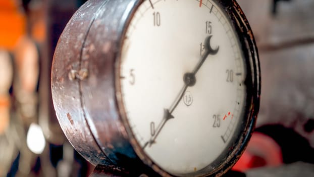 Macro image of dial and pointer on retro manometer at steam power engine