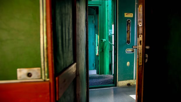 Old steam train car with long wooden corridor