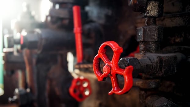 Closeup photo of old valve with stained paint on steam powered engine