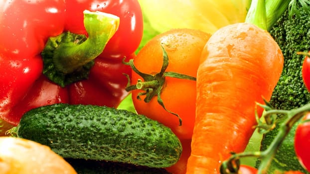 Macro imageof carrot, tomato, cucumber and bell pepper on kitchen cutting board