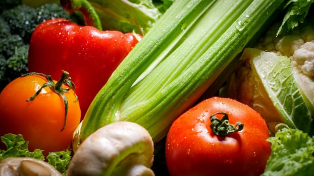 Closeup photo of washed wet vegetables on kitchen table prepared for cooking. Background for healthy food and GMO free products.Diet nutrition and fresh vegetables. Vegan and vegetarian background.