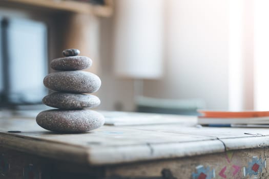 Feng Shui: Stone cairn in the foreground, blurry living room in the background. Balance and relaxation.