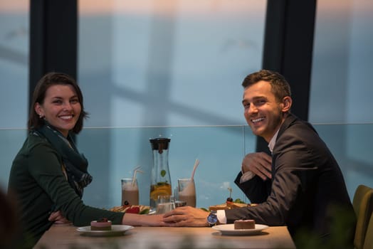 Couple celebrate Valentine's day with romantic dinner in restaurant near the window