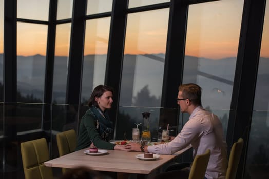 Couple celebrate Valentine's day with romantic dinner in restaurant near the window