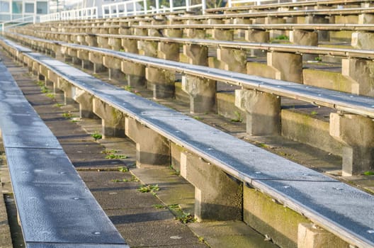 Benches,grandstand,in a stadium or arena.