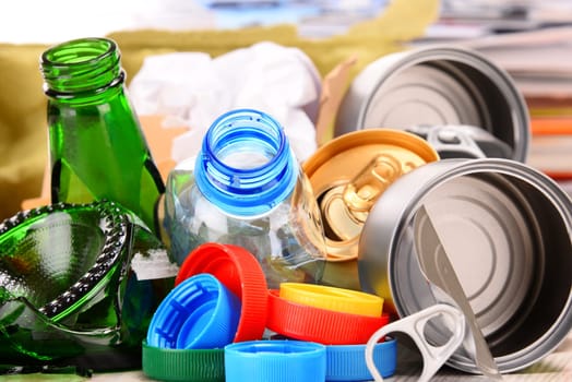 Recyclable garbage consisting of glass, plastic, metal and paper isolated on white background