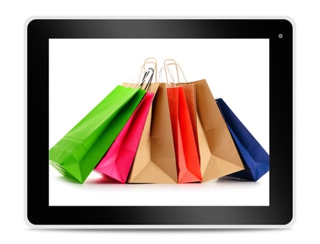Paper shopping bags on computer tablet screen. Shopping online. E-commerce