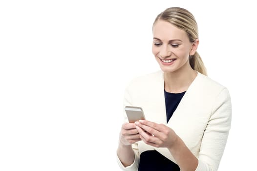 Happy woman reading a sms on her mobile phone