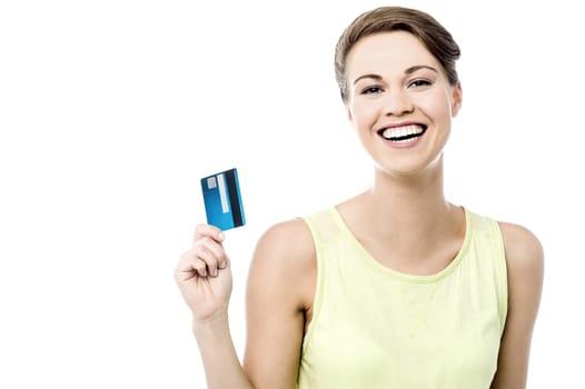 Cheerful woman showing her new credit card