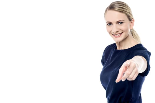 Beautiful woman pointing towards camera