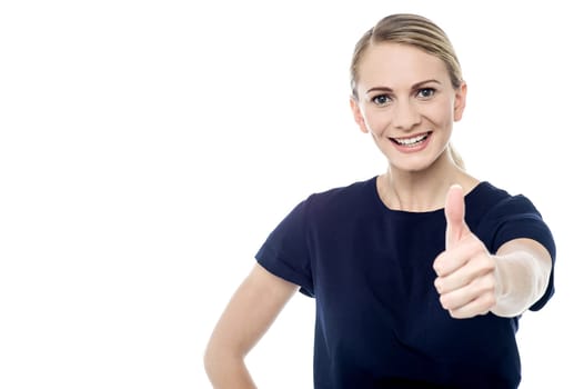 Smiling woman making thumb up gesture