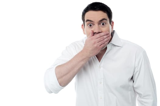 Surprised man covering his mouth with hand