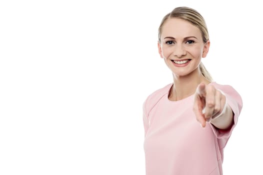 Smiling young girl pointing towards you