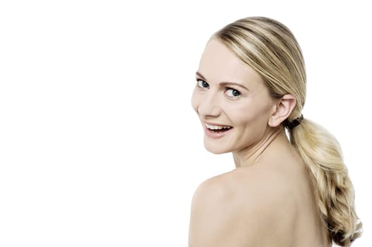 Topless woman looking back and posing to camera