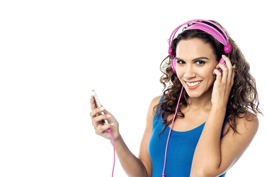 Young woman listening song from mobile phone