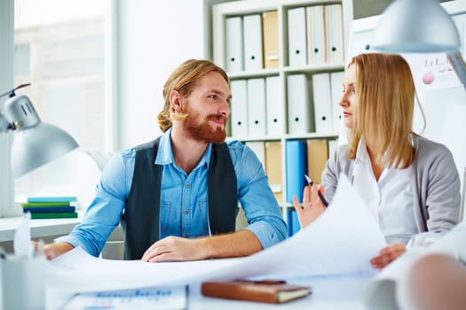 Pretty businesswoman explaining to colleague her ideas about new project