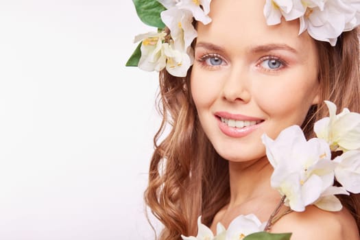 Young woman in floral wreath looking at camera