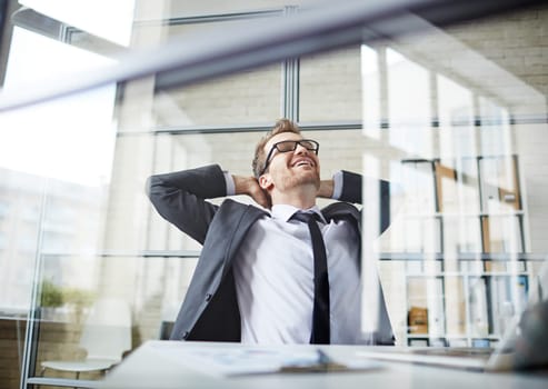 Young businessman dreaming during break in office