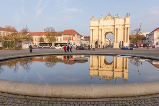 Brandenburg Gate in Potsdam is reflected in the fountain