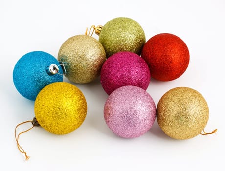 eight colored Christmas balls on awhite background