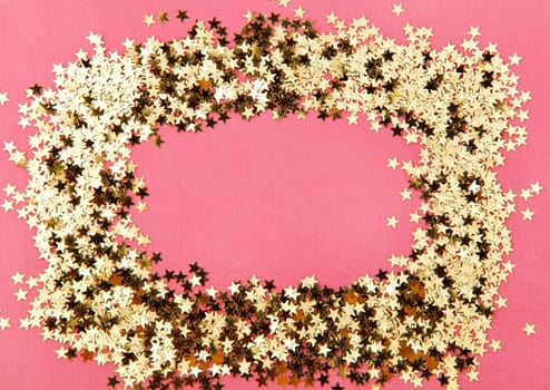 frame made of decorative stars on pink background