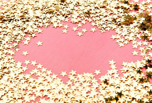 frame made of decorative stars on pink background