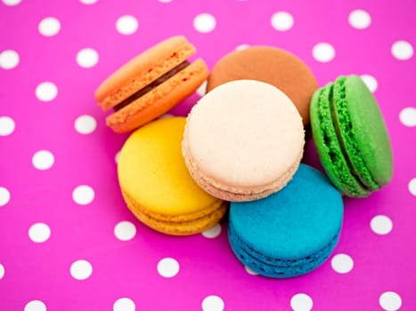 colorful macarons on pink underlay