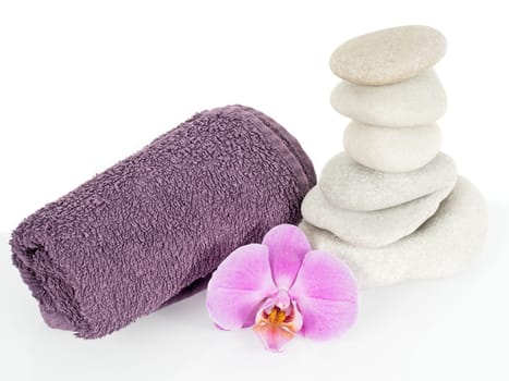 Stone tower with towel and orchid blossom