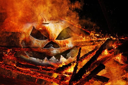 A creepy pumpkin head in the fire. A pumpkin head in the flames