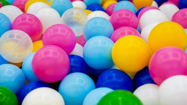 Closeup iamge of colorful plastic balls in pool on the playground at shopping mall.