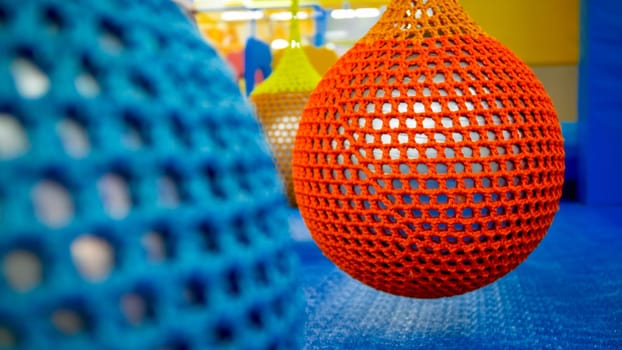Closeup photo of colroful balls for flyain air yoga hanging in fitness club or gym.