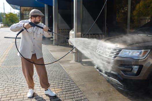 He loves his car. Man washing car. High quality photo
